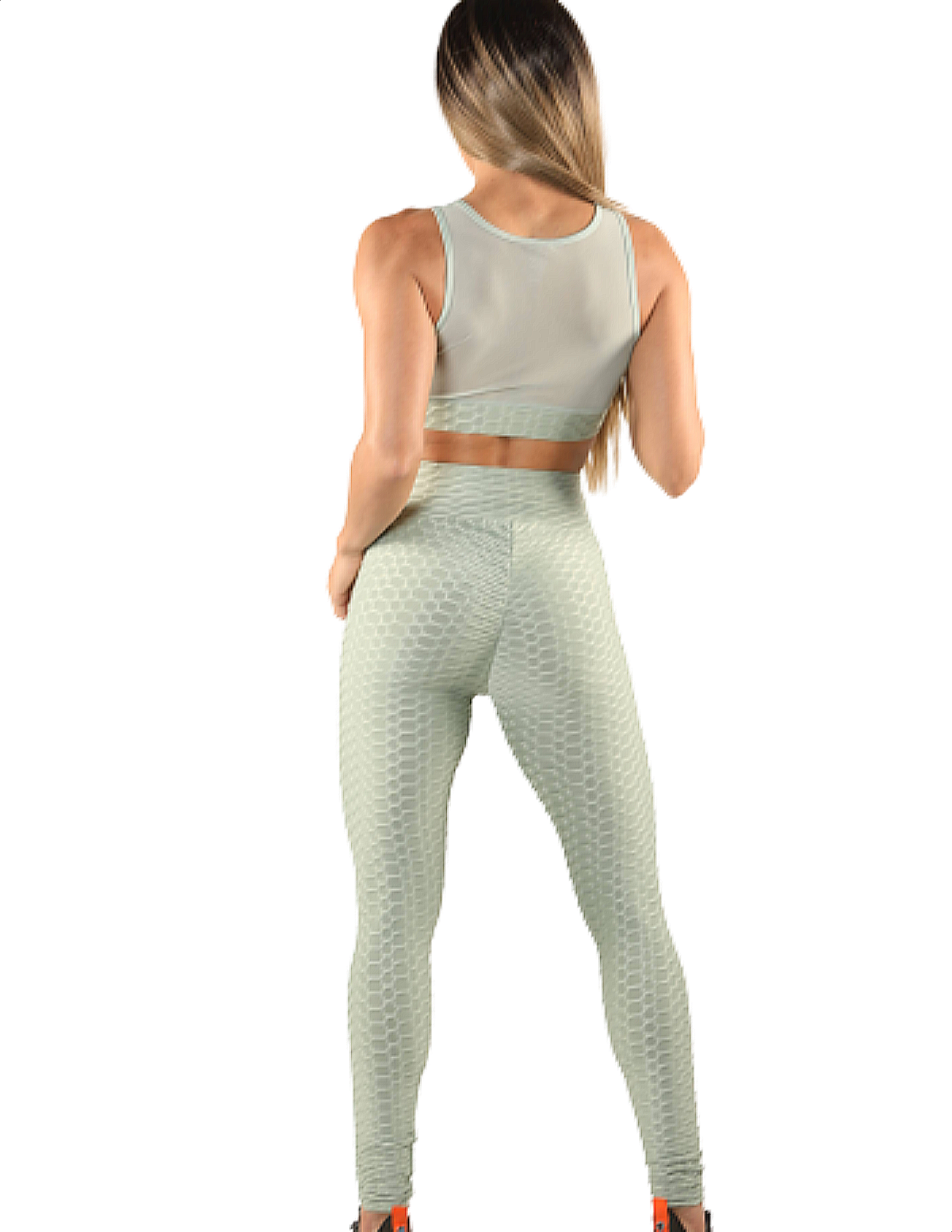 Girl wearing Shape Up Athletics popcorn textured and ruched leggings with matching sports bra in green
